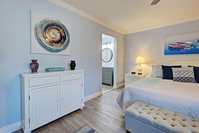 bedroom featuring ensuite bath, ceiling fan, light hardwood / wood-style flooring, and ornamental molding