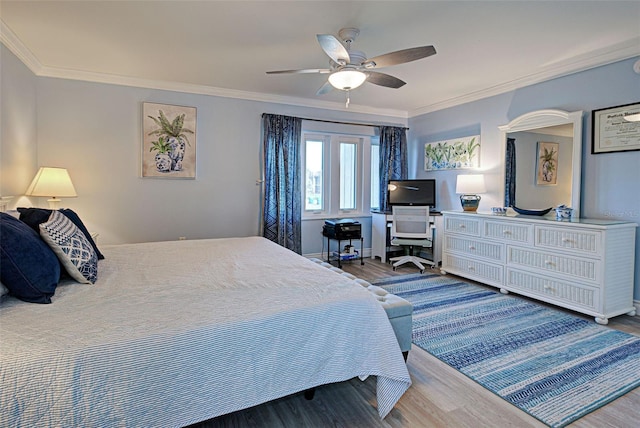 bedroom featuring ceiling fan, crown molding, and wood-type flooring