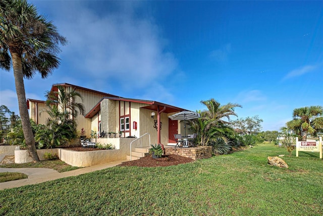 view of side of home featuring a lawn