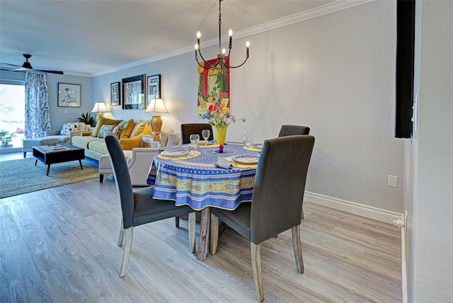 dining room featuring wood-type flooring, ceiling fan with notable chandelier, and ornamental molding