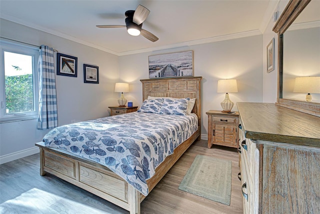 bedroom featuring ceiling fan, wood-type flooring, and ornamental molding