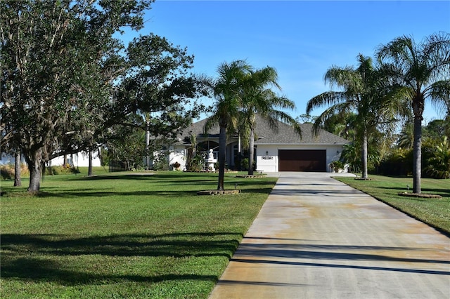 view of front facade with a front yard and a garage