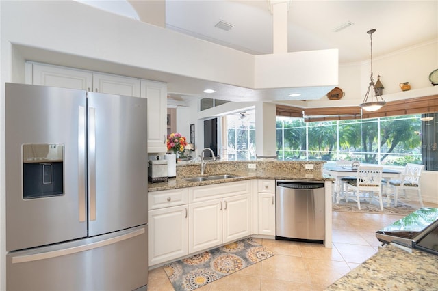 kitchen featuring white cabinets, light stone countertops, sink, and appliances with stainless steel finishes