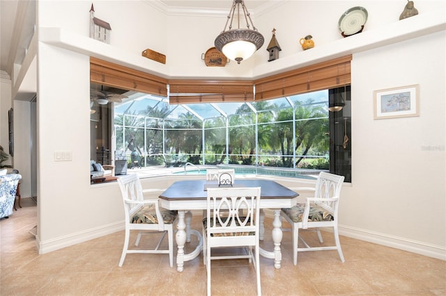 tiled dining area featuring a towering ceiling and crown molding