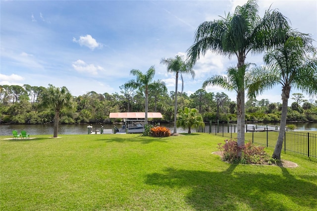 view of yard with a water view and a boat dock