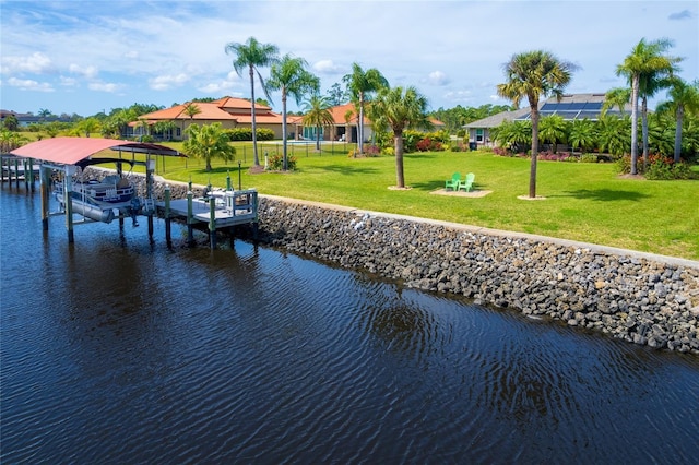 view of dock featuring a yard, a water view, and boat lift