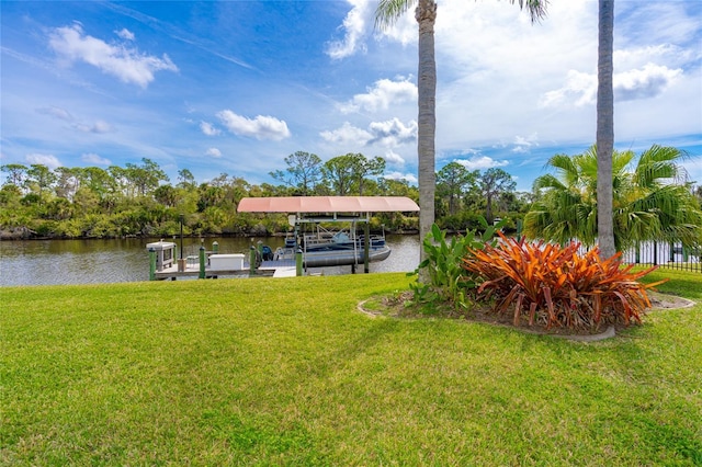 dock area featuring a yard, a water view, and boat lift