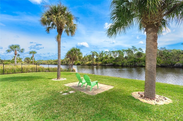 view of yard featuring fence and a water view