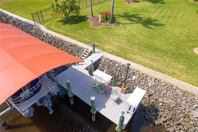 exterior space with fence, a dock, and a water view