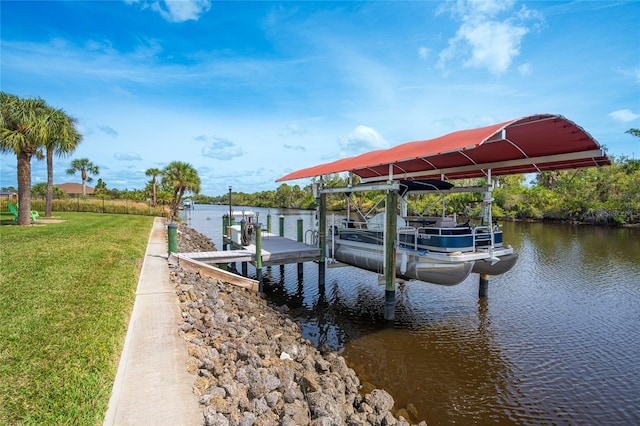 dock area featuring a yard, a water view, and boat lift