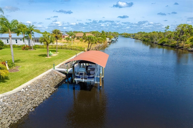 view of dock with a lawn, a water view, and boat lift