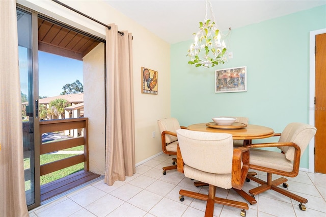 tiled dining area with an inviting chandelier