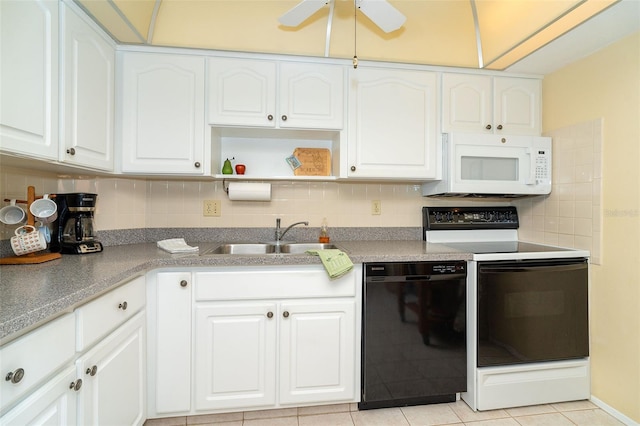 kitchen featuring stove, sink, light tile patterned floors, black dishwasher, and white cabinetry