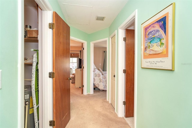 hallway featuring light carpet