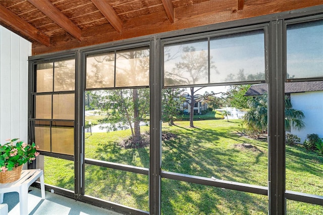 interior space featuring beamed ceiling, a water view, and wood ceiling