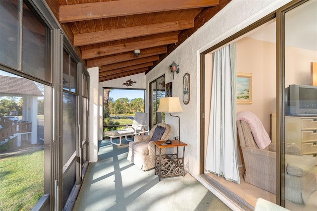 sunroom featuring vaulted ceiling with beams and wooden ceiling