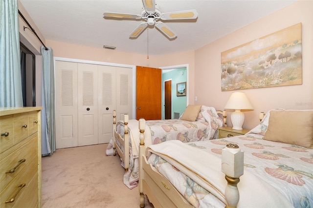 bedroom featuring light carpet, a closet, and ceiling fan