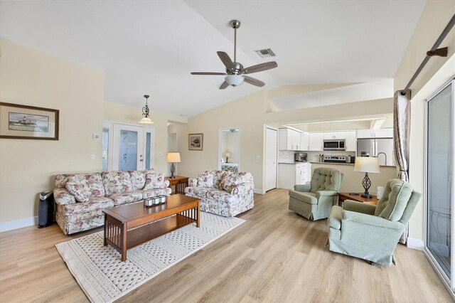 living room with vaulted ceiling, light hardwood / wood-style flooring, and ceiling fan