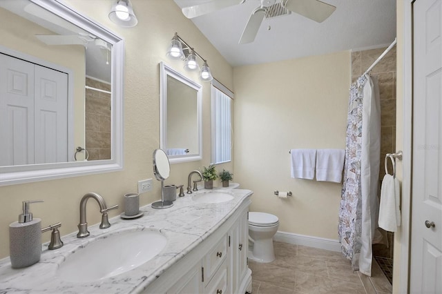 bathroom with a shower with shower curtain, vanity, ceiling fan, tile patterned flooring, and toilet