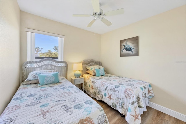 bedroom with ceiling fan and dark hardwood / wood-style floors