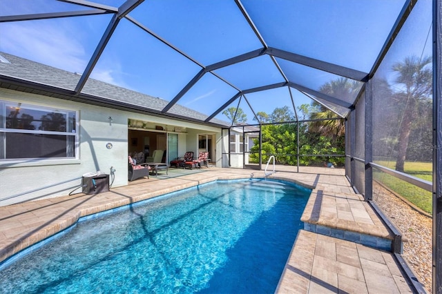 view of swimming pool featuring a lanai, ceiling fan, and a patio area