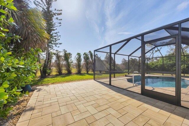 view of patio featuring glass enclosure