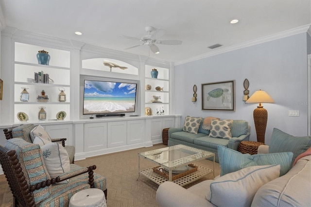 living room with built in shelves, ceiling fan, and crown molding