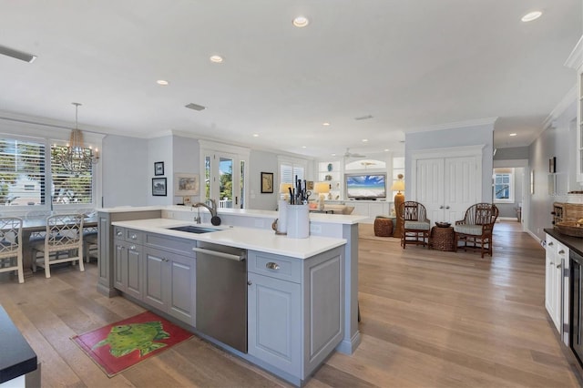 kitchen featuring gray cabinetry, dishwasher, sink, hanging light fixtures, and ornamental molding