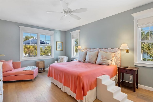 bedroom with light hardwood / wood-style flooring and ceiling fan