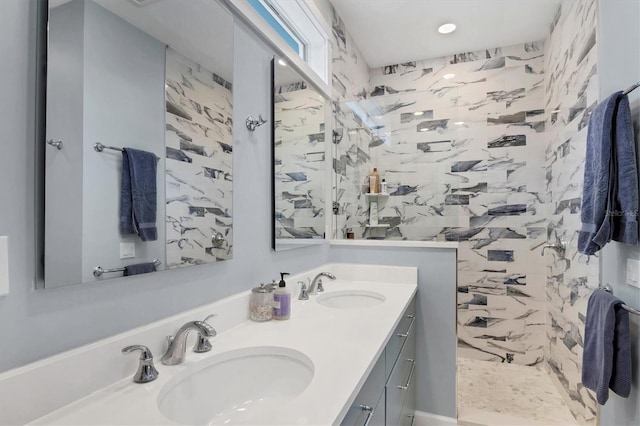 bathroom with vanity and a tile shower