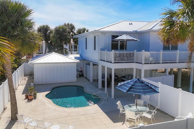 rear view of house with outdoor lounge area, a fenced in pool, and a patio area