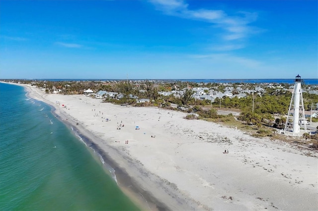 bird's eye view featuring a water view and a beach view