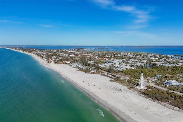 drone / aerial view with a water view and a beach view