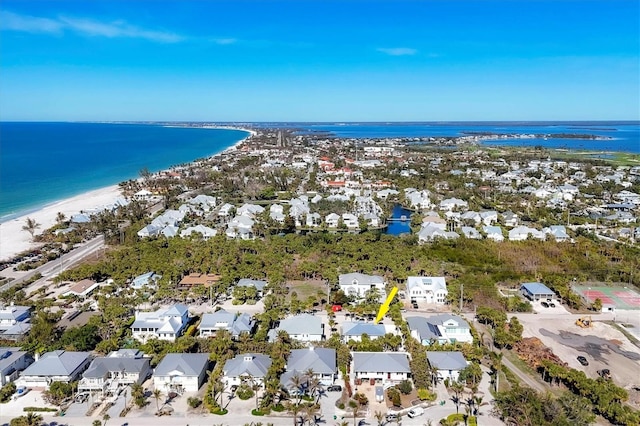 drone / aerial view featuring a view of the beach and a water view