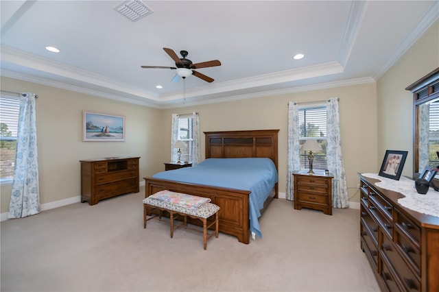 bedroom with light carpet, ceiling fan, and a raised ceiling