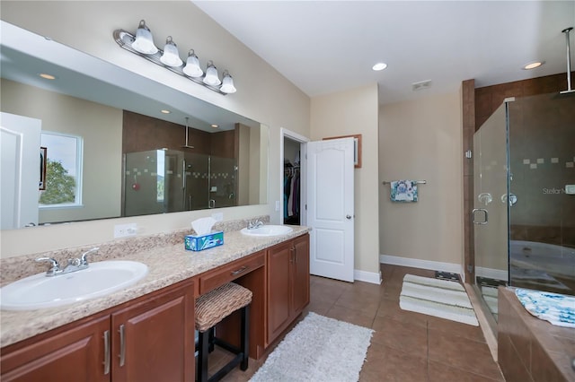 bathroom featuring vanity, tile patterned floors, and a shower with door