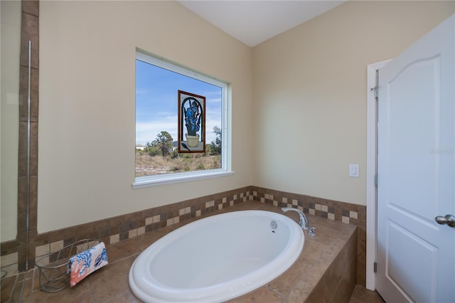 bathroom with a relaxing tiled tub