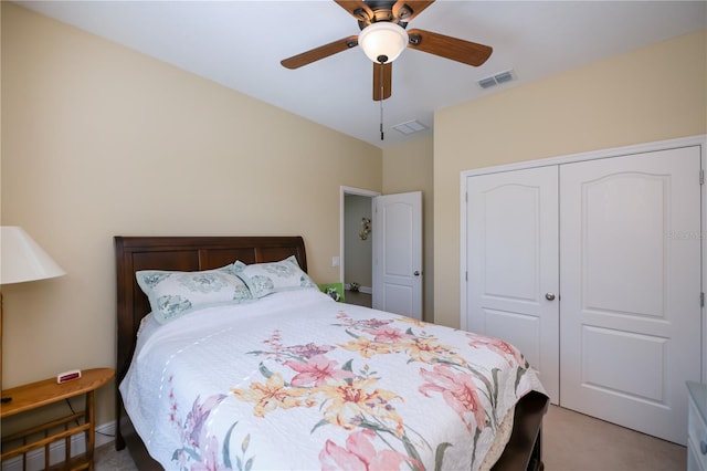 carpeted bedroom with ceiling fan and a closet