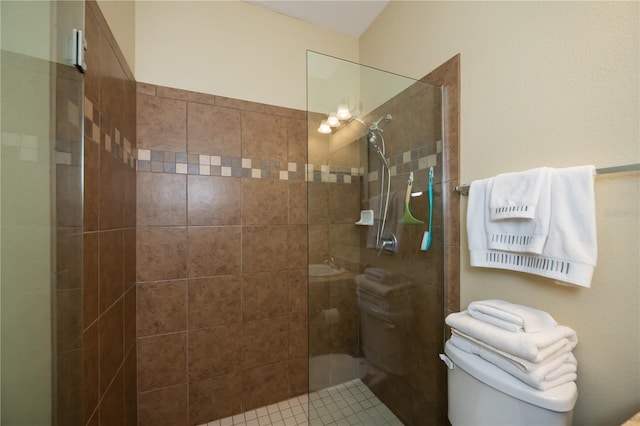 bathroom featuring toilet and tiled shower