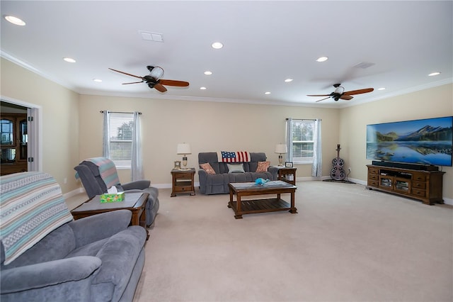 carpeted living room featuring ceiling fan, crown molding, and plenty of natural light