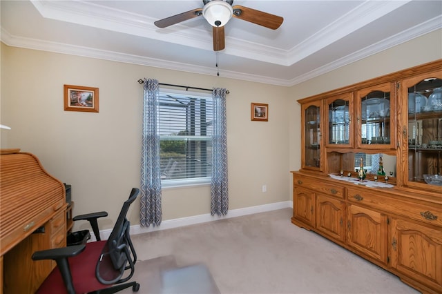 carpeted office with a raised ceiling, ceiling fan, and crown molding