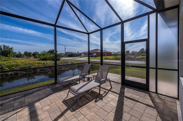 unfurnished sunroom featuring a water view