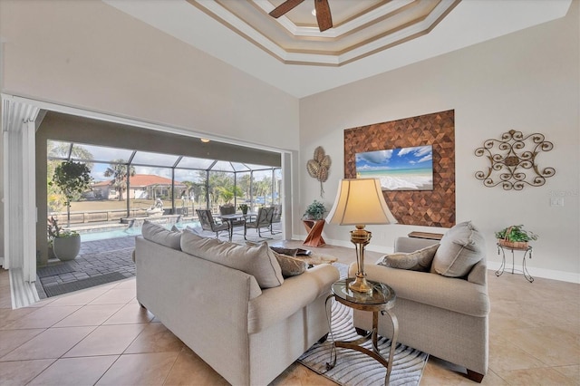 living room featuring a towering ceiling, ceiling fan, and light tile patterned flooring