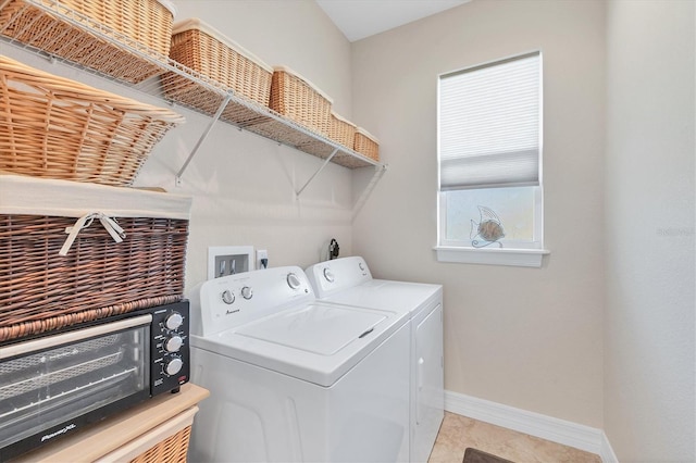 clothes washing area with washing machine and dryer