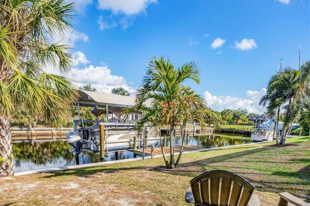 exterior space with a lawn, a water view, and a dock