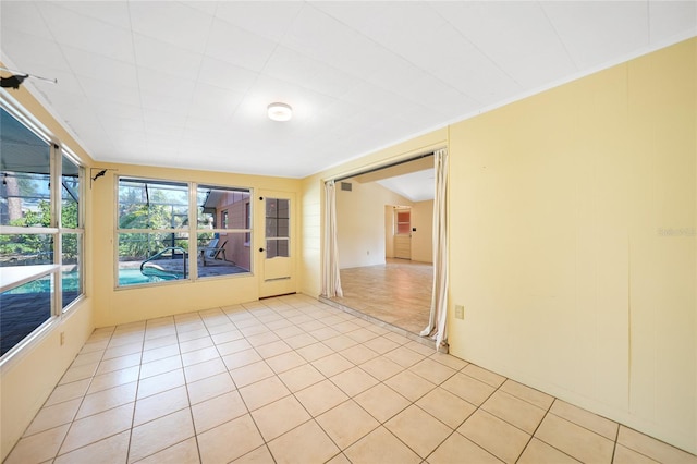 tiled spare room with a healthy amount of sunlight