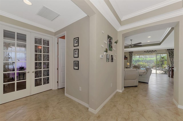 hall featuring washer / dryer, french doors, ornamental molding, and light tile patterned flooring