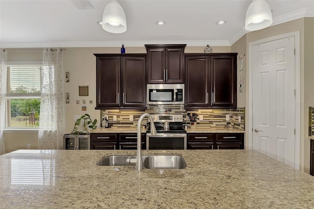 kitchen with decorative backsplash, decorative light fixtures, crown molding, and appliances with stainless steel finishes