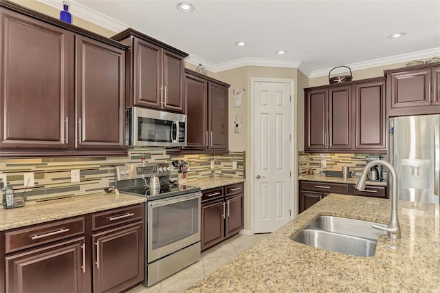 kitchen with decorative backsplash, sink, stainless steel appliances, and ornamental molding