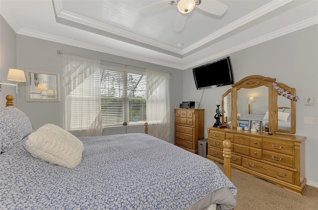 bedroom featuring ceiling fan, crown molding, and a tray ceiling